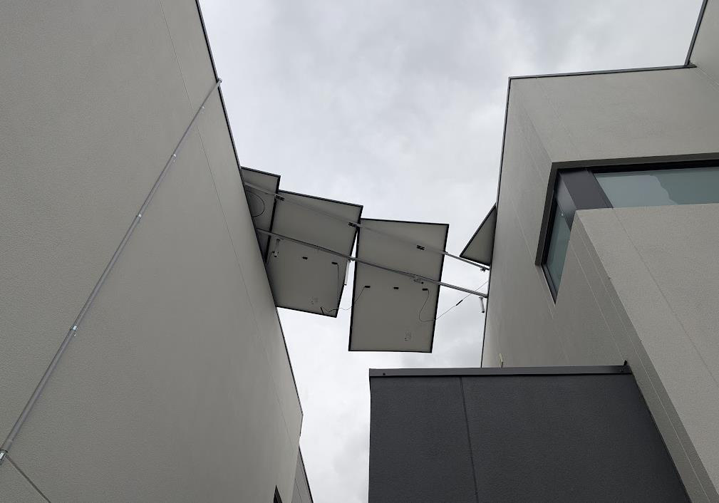 Detached solar panels hanging from residential building